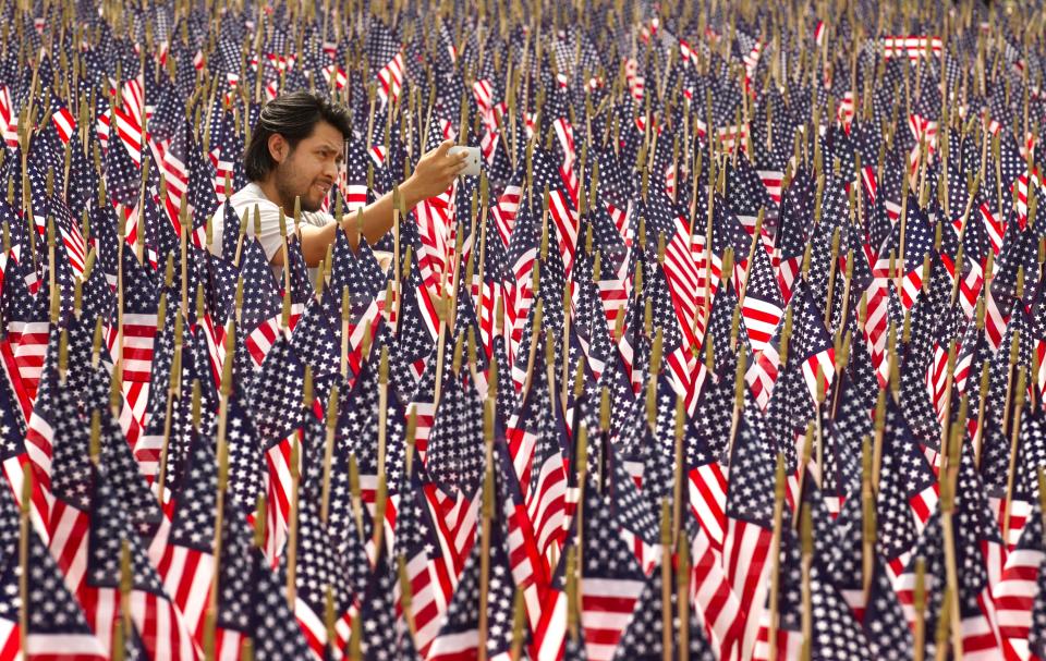 Edgar Yepez takes a photo among 7,000 American flags on display outside the Long Center on Memorial Day, May 27, 2013. The flags honored fallen veterans of the wars in Iraq and Afghanistan. (Jay Janner/AMERICAN-STATESMAN)
(Photo: Jay Janner)