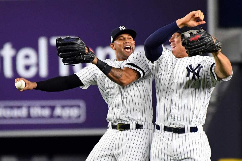 Oct 18, 2017; Bronx, NY, USA; New York Yankees center fielder Aaron Hicks (31) and right fielder Aaron Judge (99) celebrates after beating the Houston Astros in game five of the 2017 ALCS playoff baseball series at Yankee Stadium. (USA TODAY Sports)