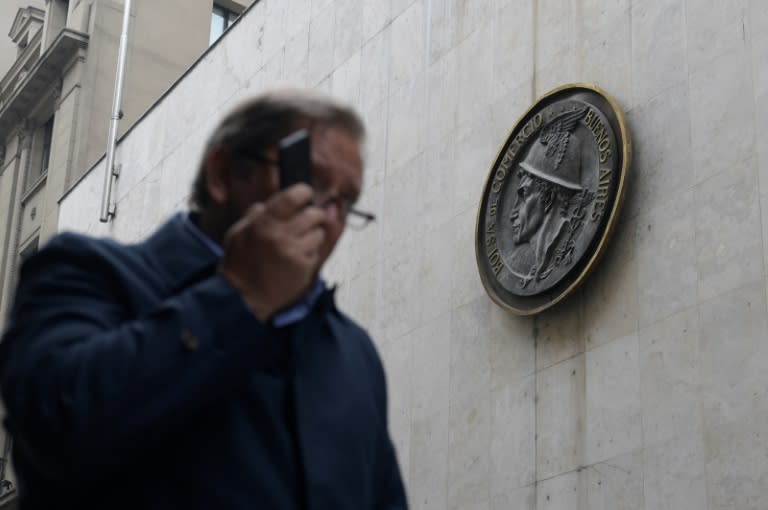 A man speaks on his mobile phone as he walks past the Buenos Aires Stock Exchange on September 3, 2018, a day in which Argentine President Mauricio Macri announced sweeping austerity measures