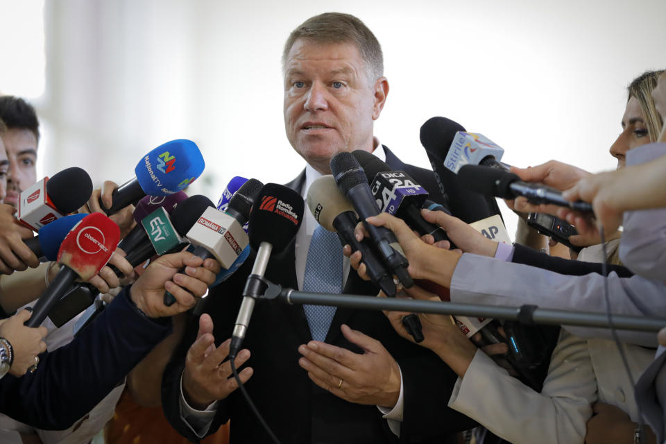 Romanian President Klaus Iohannis speaks to media after casting his vote in Bucharest, Romania, Sunday, Nov. 10, 2019. Voting got underway in Romania's presidential election after a lackluster campaign overshadowed by a political crisis which saw a minority government installed just a few days ago. (AP Photo/Vadim Ghirda)