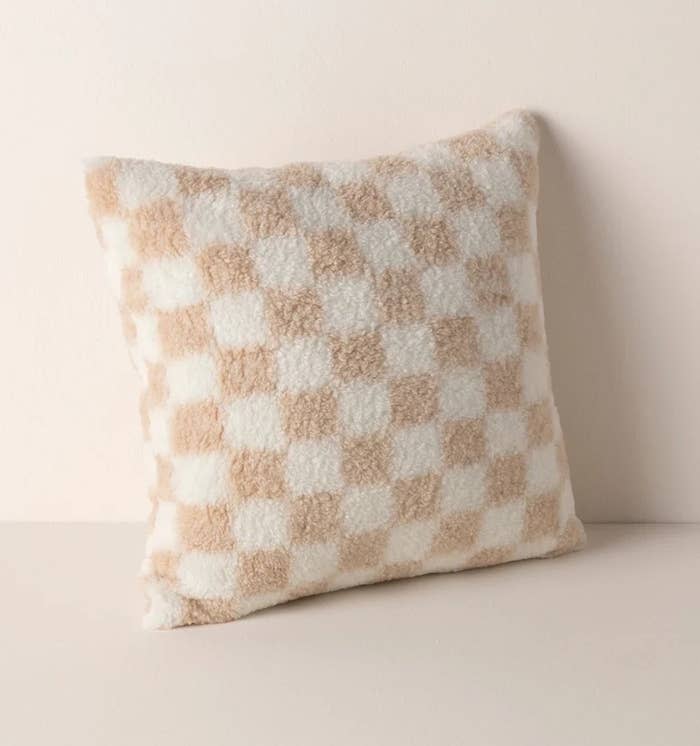 white and tan plushy checkered throw pillow