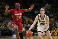 Iowa guard Caitlin Clark (22) drives up court past Maryland guard Bri McDaniel (24) during the second half of an NCAA college basketball game, Thursday, Feb. 2, 2023, in Iowa City, Iowa. Iowa won 96-82. (AP Photo/Charlie Neibergall)