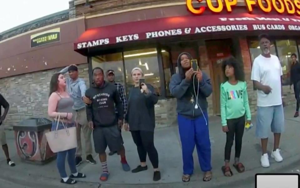 Darnella Frazier, third from right, films the killing of George Floyd in Minneapolis last year - REUTERS