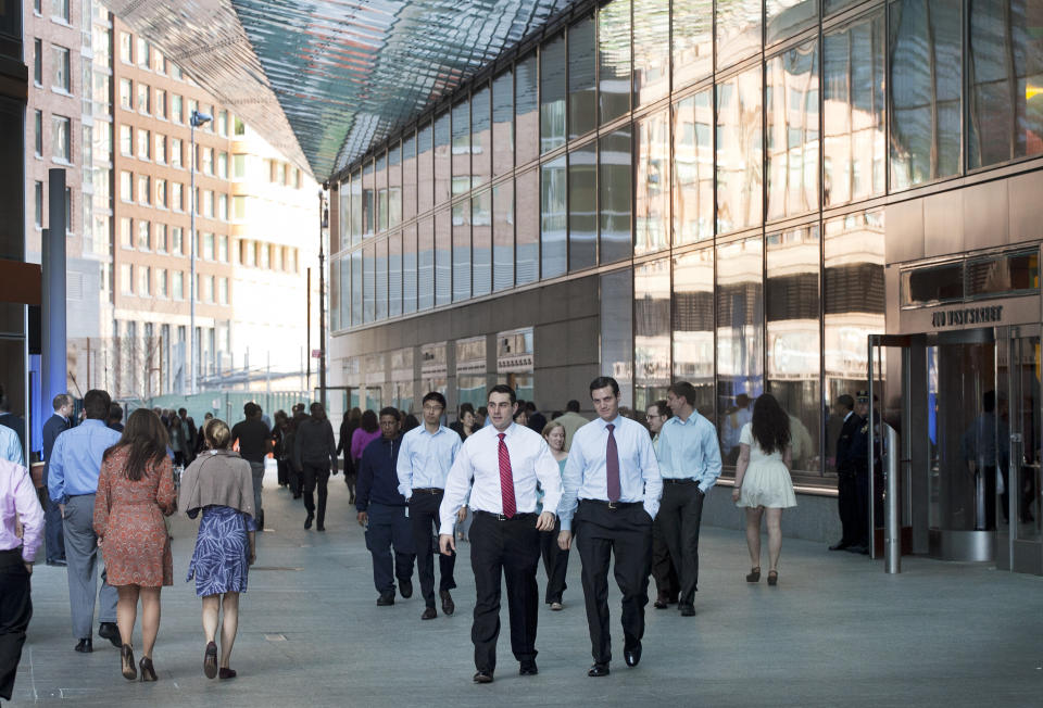 FILE- In this March 14, 2012, file photo people come and go from Goldman Sachs headquarters in New York. Business casual has become such an entrenched trend that even Goldman Sachs surrendered to it with a memo to employees announcing flexible dress code. (AP Photo/Mark Lennihan, File)