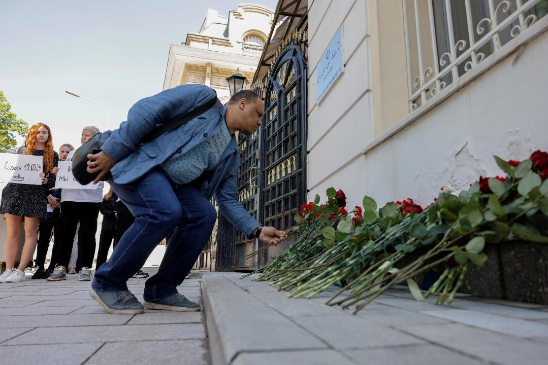 A man lays flowers outside the Iranian embassy to pay tribute to Iran's President Ebrahim Raisi, Foreign Minister Hossein Amirabdollahian and other victims of a recent helicopter crash in mountainous terrain near Iran's border with Azerbaijan, in Moscow, Russia, May 20, 2024. REUTERS/Maxim Shemetov