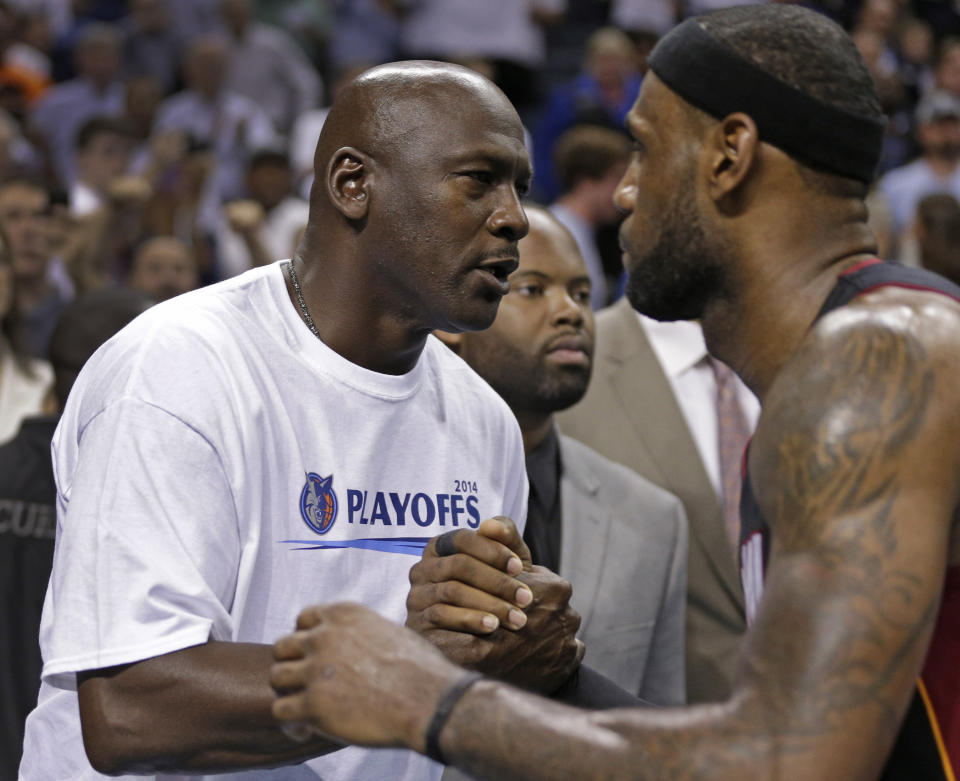 LeBron James and Michael Jordan try to get the upper hand. (AP)