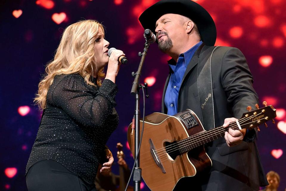 <p>John Shearer/Getty</p> Trisha Yearwood and Garth Brooks perform together in Nashville in April 2019