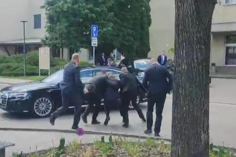 TOPSHOT - This image taken from video footage obtained by AFPTV shows security personnel carrying Slovakia's Prime Minister Robert Fico (C) towards a vehicle after he was shot in Handlova on May 15, 2024. Slovakia's Prime Minister Robert Fico was battling life-threatening wounds after officials said he was shot multiple times in an assassination attempt condemned by European leaders. (Photo by RTVS / AFP) (Photo by -/RTVS/AFP via Getty Images)