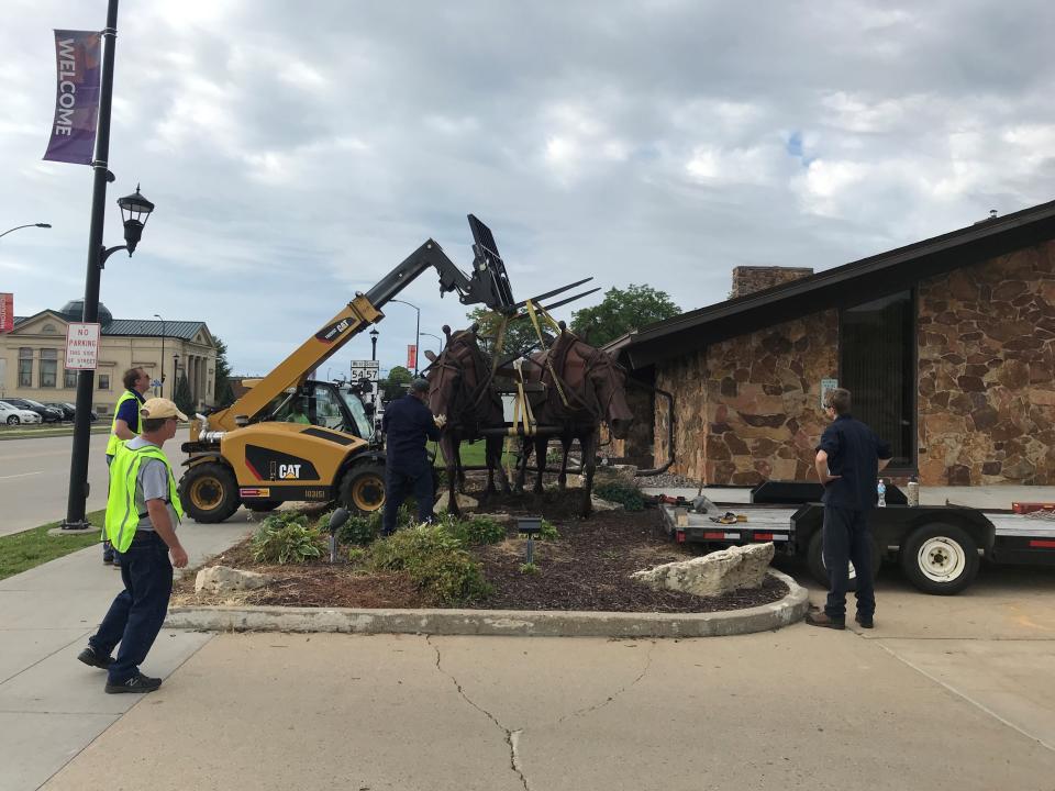 Renco Machine Co. moves the "Logger: statue to a trailer Tuesday, August 13, 2019, from the former Bank Mutual location on North Monroe Avenue in Green Bay, Wis. The statue was given to the Neville Museum by Associated Bank and will be displayed outside.