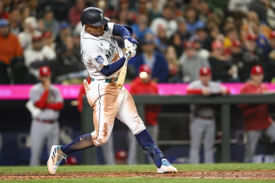 Seattle Mariners' Julio Rodriguez hits a single against the St. Louis Cardinals during the seventh inning of a baseball game Friday, April 21, 2023, in Seattle. (AP Photo/Caean Couto)