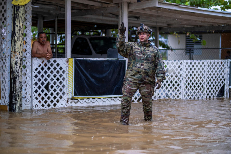 <p>A member of the Puerto Rico National Guard search for people to be rescued from flooded streets in the aftermath of Hurricane Fiona in Salinas, Puerto Rico September 19, 2022. REUTERS/Ricardo Arduengo</p> 