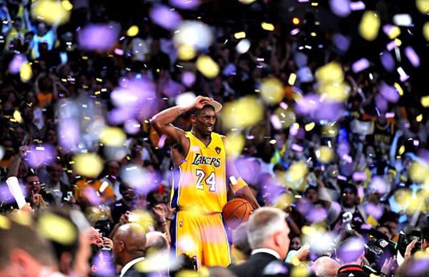 Kobe Bryant stands on the scorers' table at Staples Center after the Lakers defeated the Celtics to win the NBA championship on Thursday night at Staples Center.