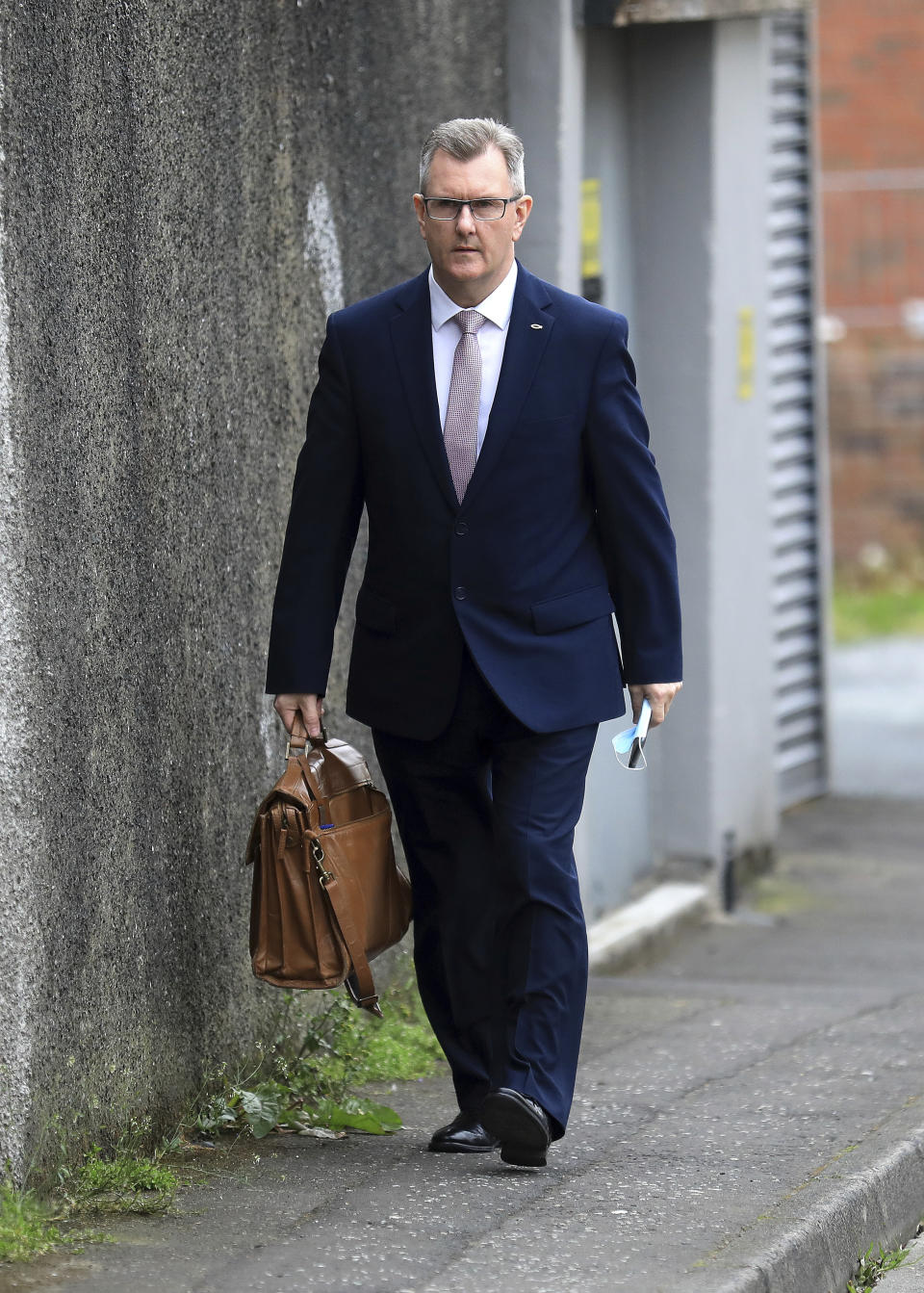 Democratic Unionist Party member Jeffrey Donaldson MP leaves the party headquarters in east Belfast after voting took place to elect a new leader on Friday May 14, 2021. Edwin Poots and Jeffrey Donaldson are running to replace Arlene Foster. (AP Photo/Peter Morrison)