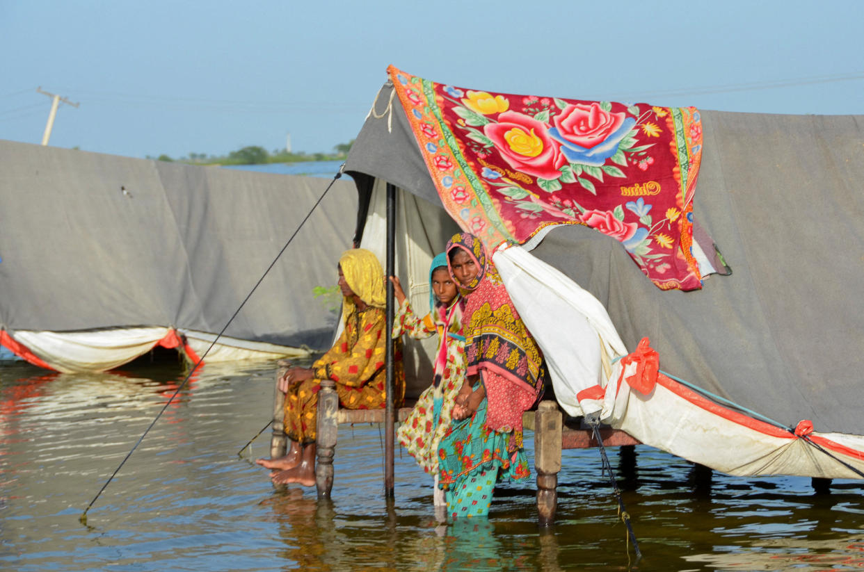 Flood victim family take refuge with their belongings as floodwater rises, following rains and floods during the monsoon season in Sohbatpur, Pakistan September 4, 2022. (Amer Hussain/Reuters)