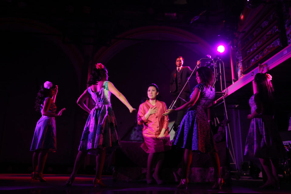 This undated theater image released by The Public Theater shows Ruthie Ann Miles, center, during a performance of "Here Lies Love," in New York. (AP Photo/The Public Theater, Joan Marcus)