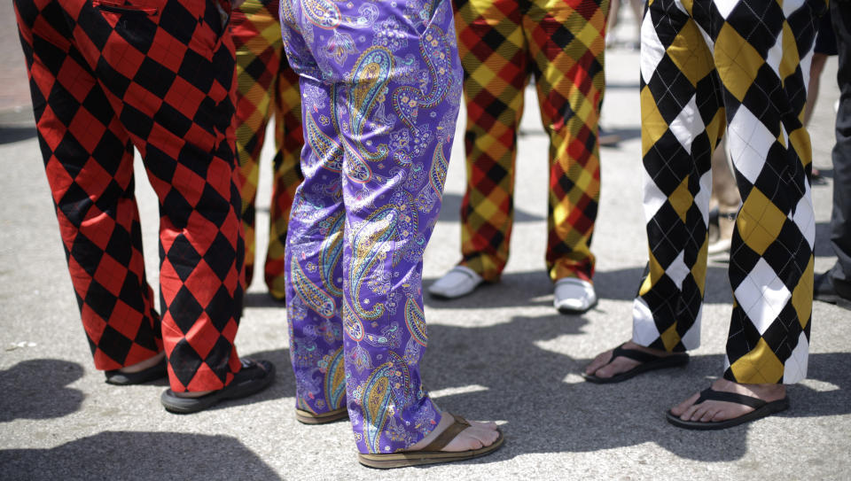 Spectators wear colorful pants before the 140th running of the Kentucky Derby horse race at Churchill Downs Saturday, May 3, 2014, in Louisville, Ky. (AP Photo/David Goldman)