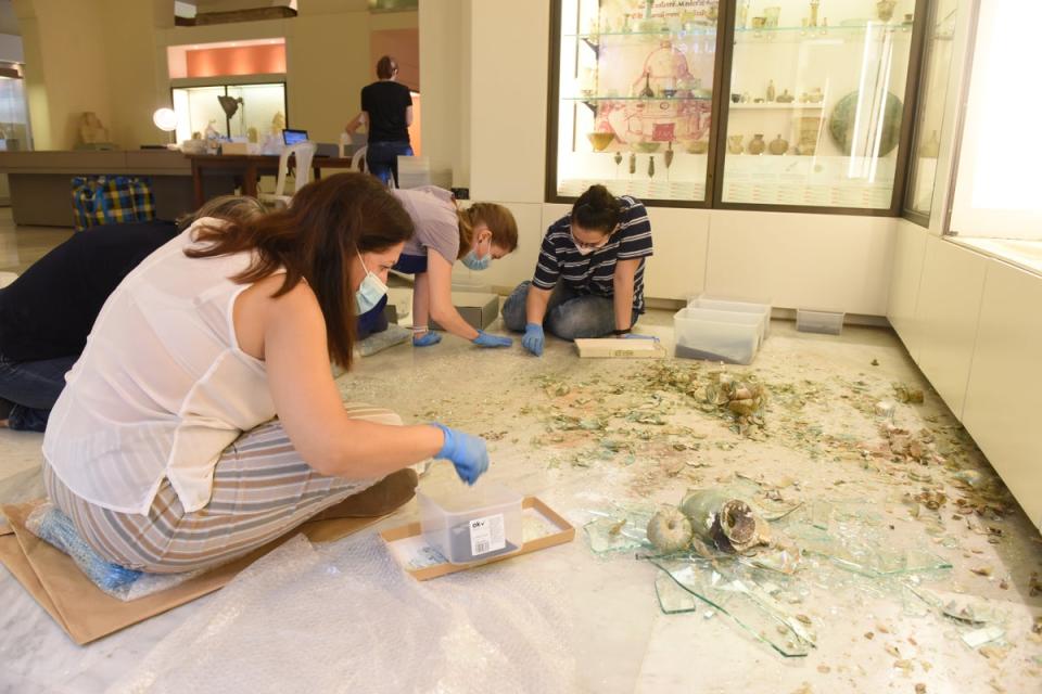 A team of conservator and student volunteers retrieve fragments of broken glass vessels at the Archaeological Museum at the American University of Beirut (AUB/British Museum/PA) (PA Media)