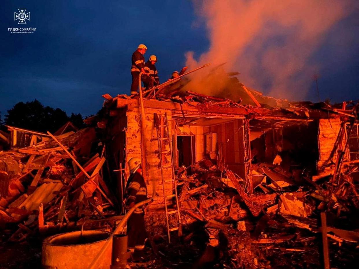 Firefighters work at a site of residential area heavily damaged during a Russian missile strike, amid Russia's attack on Ukraine, in the town of Zviahel, Zhytomyr region (via REUTERS)