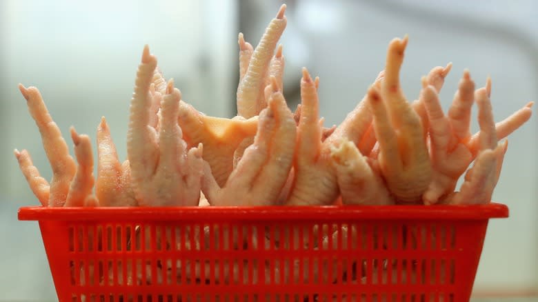 Close-up of a red basket full of chicken feet