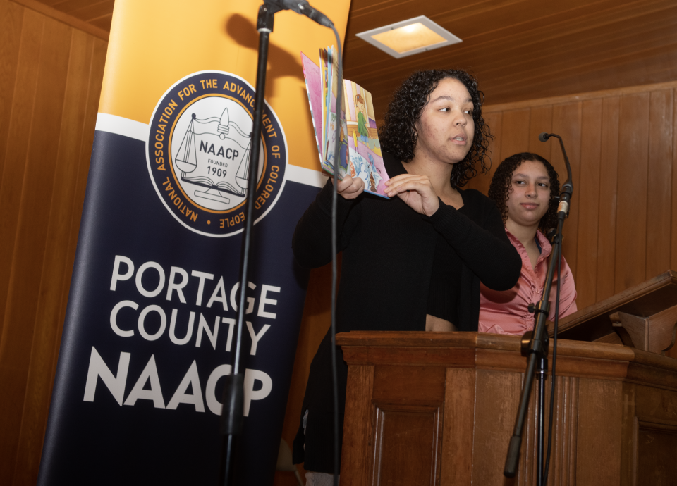 Briah Daniel and Mariah Woods, members of the Windham High School chapter of the NAACP,  talk about diversity, reading the book "The Crayon Box That Talked" by Shane DeRolf.