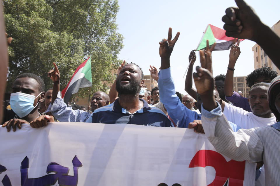 Sudanese demonstrators take to the streets of the capital Khartoum to demand the government's transition to civilian rule in Khartoum, Sudan, Thursday, Oct. 21, 2021. The relationship between military generals and Sudanese pro-democracy groups has deteriorated in recent weeks over the country's future. (AP Photo/Marwan Ali)