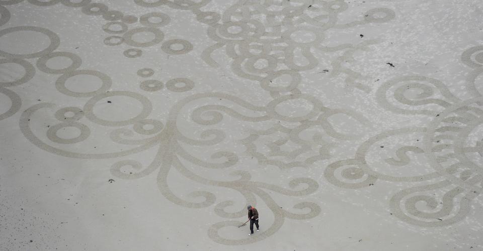 Sand ArtU.S artist Andres Amador walks through his creation on Plemont beach for the MyMemory.com World Beach Art Championships in Jersey, Channel Islands on October, 30, 2011.Competitors battled it out by drawing masterpieces in the sand with French artist Sam Dougados crowned champion for his design of parallel lines and concentric circles.However, tourists didn't have long to appreciate the artworks -- the sea soon turned the beach into a blank canvas again.Jersey - November 2011Mandatory Credit:  Carl Court.Supplied by WENN.com