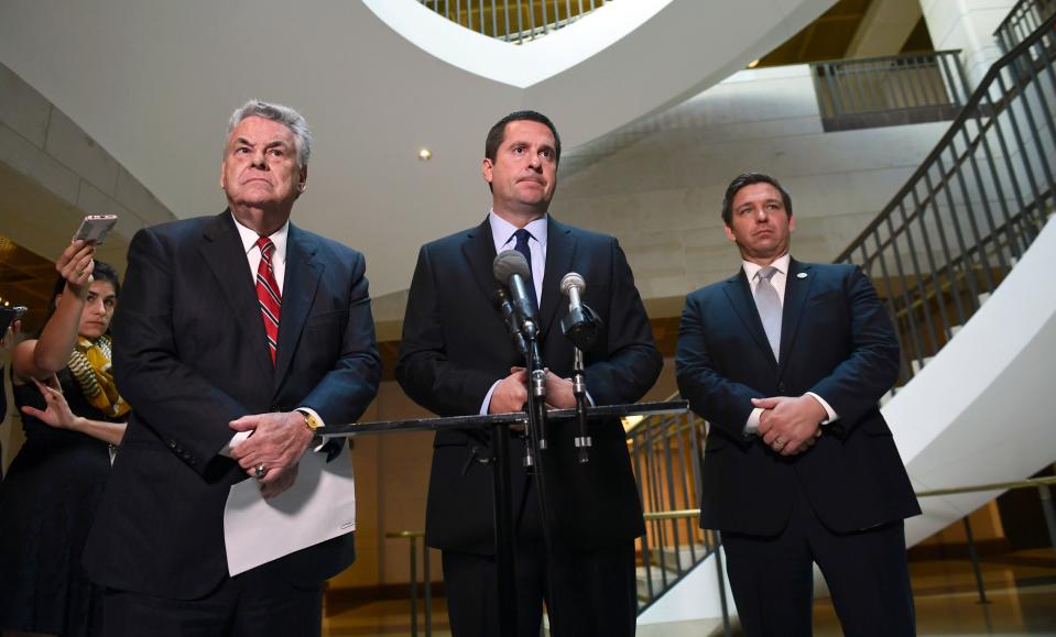 House Intelligence Chairman Devin Nunes, standing with Reps. Peter King and Ron DeSantis, listens to a reporter's question as he speaks on Capitol Hill on Oct. 24, 2017.