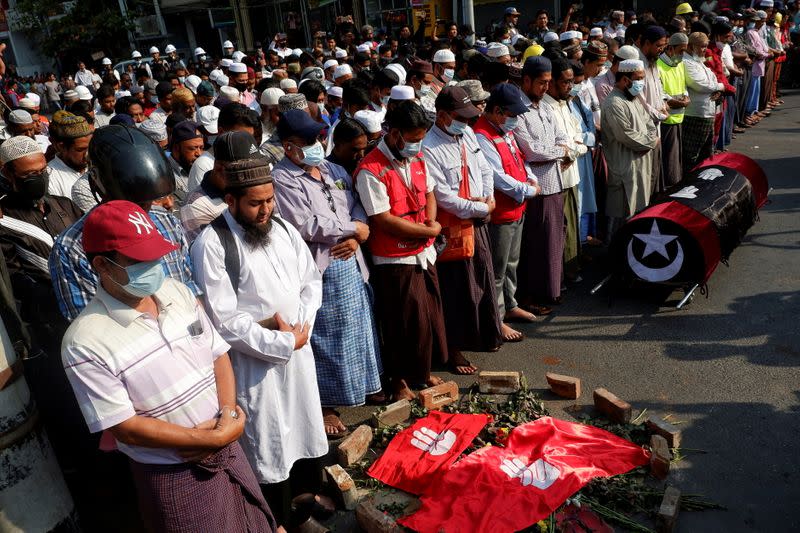People attend the funeral of a woman who was shot dead during an anti-coup demonstration in Mandalay