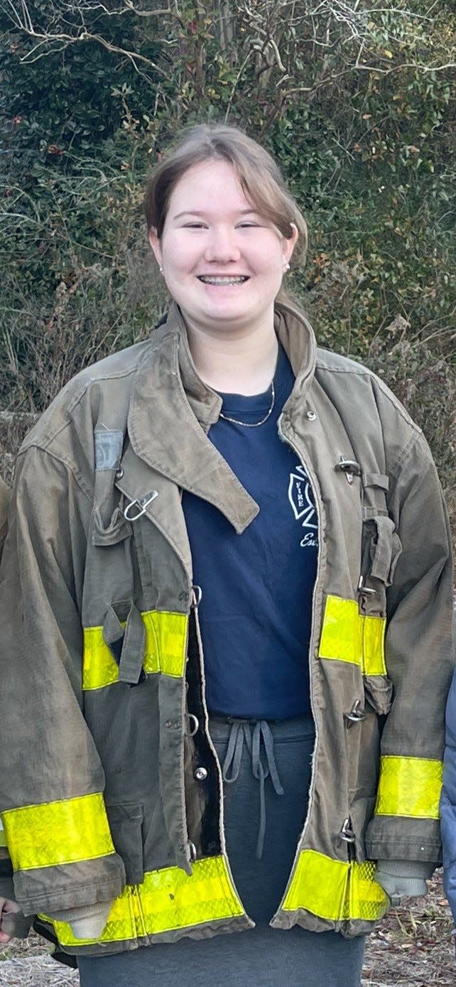 Haylee Richardson pictured wearing some of her father's firefighting gear.