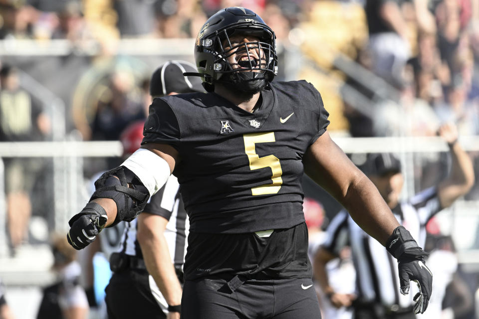 Central Florida defensive tackle Ricky Barber (5) celebrates after sacking Cincinnati quarterback Ben Bryant during the first half of an NCAA college football game, Saturday, Oct. 29, 2022, in Orlando, Fla. (AP Photo/Phelan M. Ebenhack)