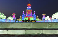 Tourists visit ice sculptures on the night before the opening ceremony of the 13th Harbin Ice and Snow World in Harbin, Heilongjiang province January 4, 2012. The Harbin International Ice and Snow Festival will be officially launched on January 5, 2012. Picture taken January 4, 2012. REUTERS/Sheng Li (CHINA - Tags: ENVIRONMENT SOCIETY TRAVEL)