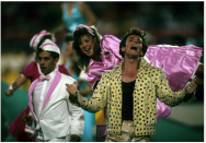 <div class="caption-credit"> Photo by: Getty Images/Rob Brown</div>In 1989, impersonator Elvis Presto gave a crazy-kitsch performance in Miami. The former Solid Gold dancer wore belly-high gold lame pants and a studded jacket, and he and did a card trick.