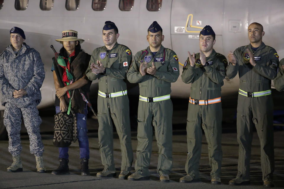 CORRECTS BROTHERS TO CHILDREN - Air Force officers applaud during the arrival of four Indigenous children who were missing after a deadly plane crash, at the military air base in Bogota, Colombia, Saturday, June 10, 2023. The children survived a small plane crash 40 days ago and had been the subject of an intense search in the jungle. (AP Photo/Ivan Valencia)