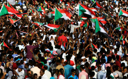 Sudanese demonstrators wave their national flags as they chant slogans during the sit-in protest outside Defence Ministry in Khartoum, Sudan April 18, 2019. REUTERS/Stringer