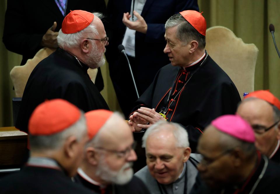 Chicago Archbishop Cardinal Blase J. Cupich, right, talks with Cardinal Reinhard Marx, as they wait for the arrival of Pope Francis for the third day of a Vatican's conference on dealing with sex abuse by priests, at the Vatican, Saturday, Feb. 23, 2019.