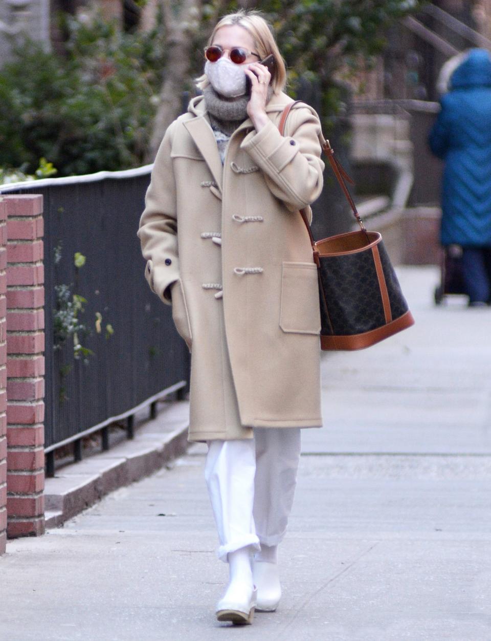 <p>Michelle Williams steps out in a tan winter coat and white trousers as she chats on the phone while walking through N.Y.C. on Sunday.</p>