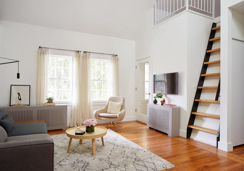 After: “I love our high-sloped ceiling in the living room and the skylights we added,” says Claudia. “They bring so much light into the space—they were worth every penny!” Shop it out: sofa, light, and coffee table.