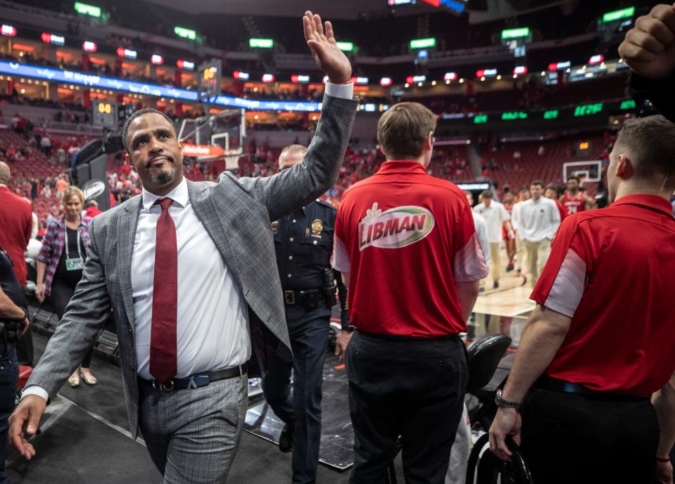 Louisville interim coach Mike Pegues waves to the crowd after his last home game at the YUM Center, losing 71-61 to Virginia. March 5, 2022