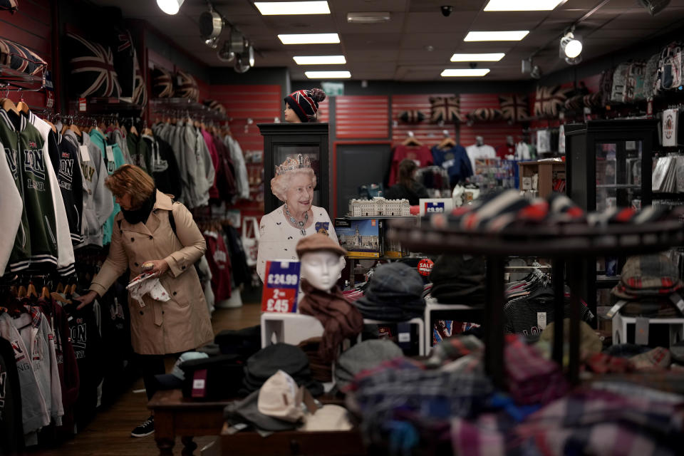 A life size cardboard cutout image of Britain's Queen Elizabeth II stands next to souvenir items inside the Cool Britannia store near Buckingham Palace, in London, May 26, 2022. (AP Photo/Matt Dunham)