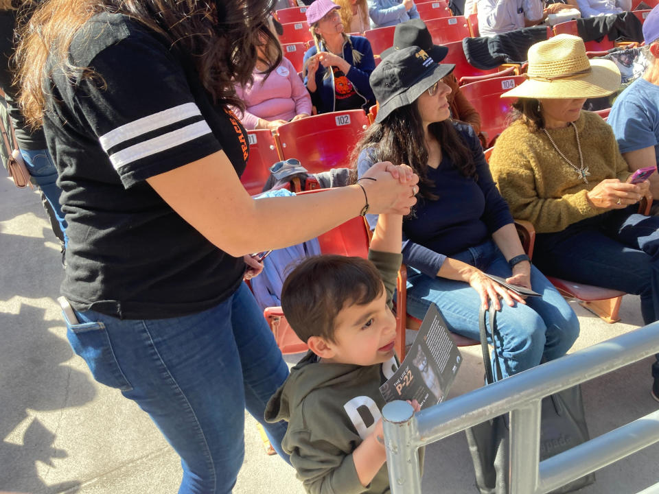 Keymi Ordeñana helps her son, Miguel Ordeñana, walk around during the P-22 mountain lion memorial on Saturday, Feb. 4, 2023 at the Greek Theater in Los Angeles. Keymi Ordeñana is the wife of Miguel Ordeñana and their son is also named Miguel Ordeñana. The elder Miguel Ordeñana is a wildlife biologist whose trail camera first captured a photo of P-22, the famed mountain lion in Griffith Park who was euthanized in December. (AP Photo/Stefanie Dazio)