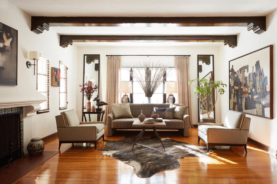 Original 1930s stenciled beams set the tone for the designer’s earthy palette. Lounge chairs from the Jeff Andrews collection for A. Rudin.