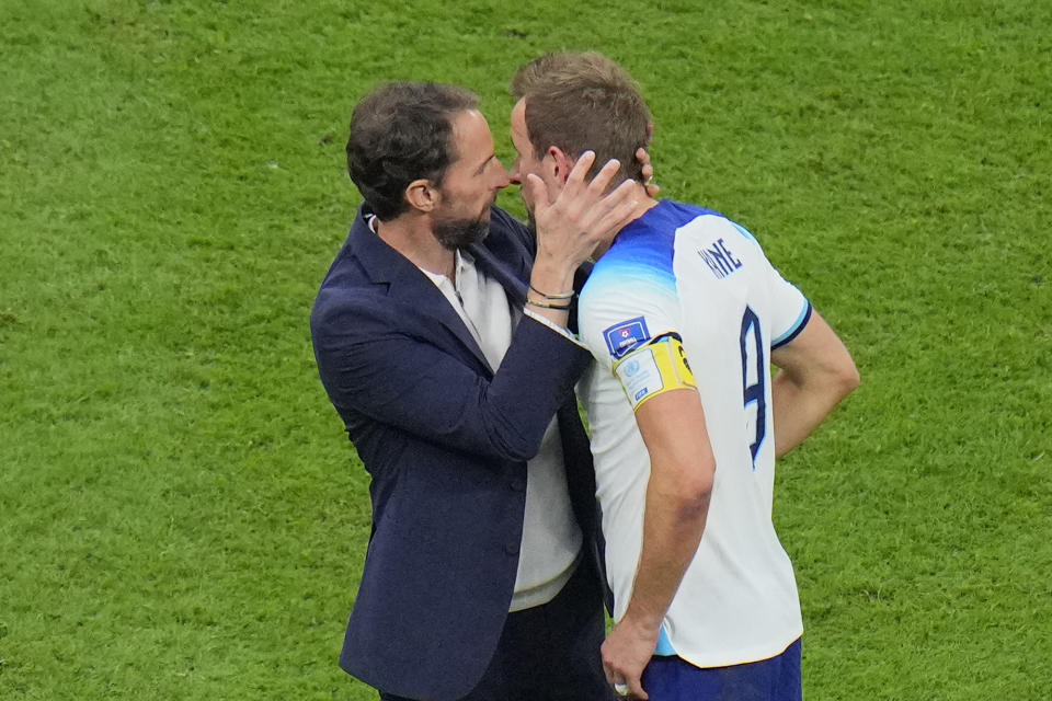 England's head coach Gareth Southgate embraces Harry Kane after the World Cup quarterfinal soccer match between England and France, at the Al Bayt Stadium in Al Khor, Qatar, Sunday, Dec. 11, 2022. (AP Photo/Hassan Ammar)