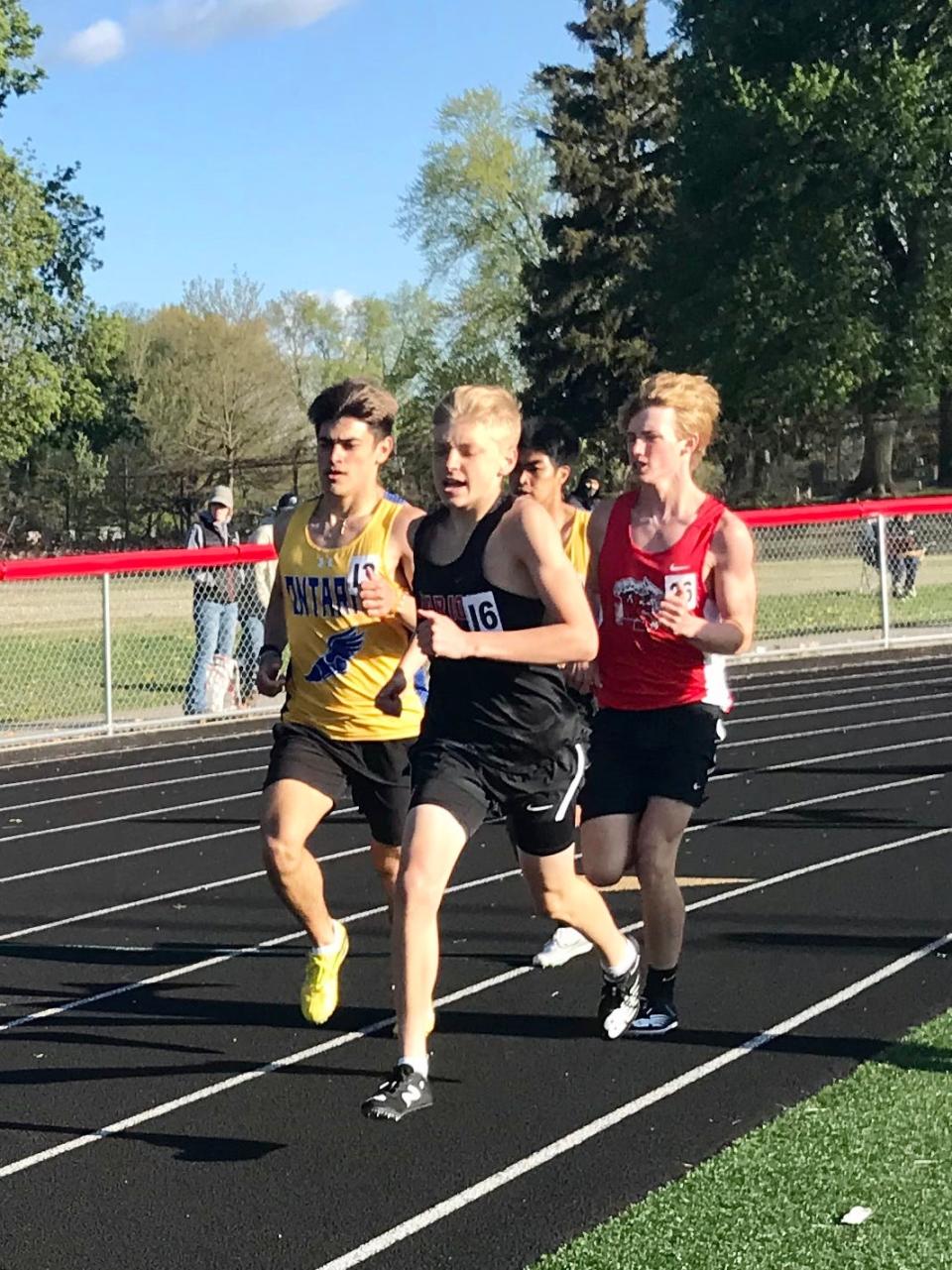 Marion Harding's Kade Sutherland, center, runs the boys 1600 during the 71st Marion Night Invitational last year in Harding Stadium.