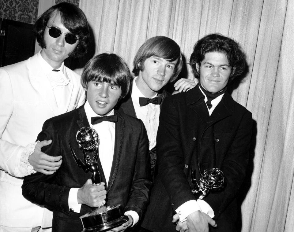 FILE - This June 4, 1967 file photo shows, from left, Mike Nesmith, Davy Jones, Peter Tork, and Micky Dolenz of The Monkees posing with their Emmy award for best comedy series at the 19th Annual Primetime Emmy Awards in Los Angeles. Tork, who rocketed to teen idol fame in 1965 playing the lovably clueless bass guitarist in the made-for-television rock band The Monkees, died Thursday, Feb. 21, 2019, of complications related to cancer, according to his son Ivan Iannoli. He was 77. (AP Photo, File)