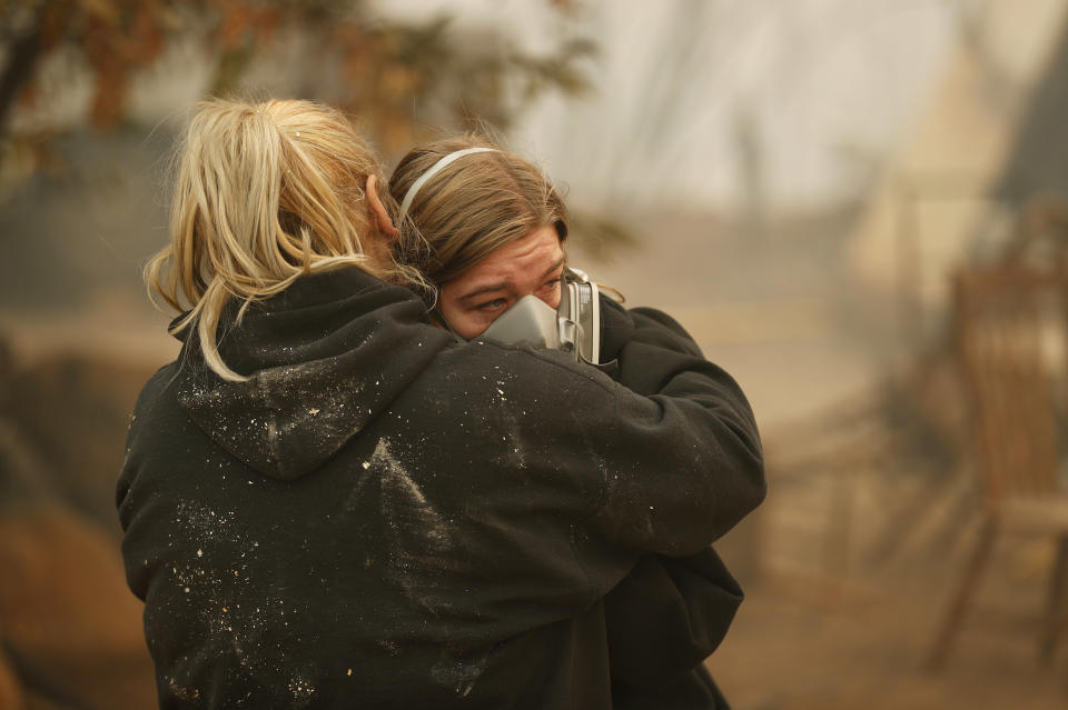 Krystin Harvey, left, comforts her daughter Araya Cipollini at the remains of their home in Paradise, California. Source: AP Photo/John Locher