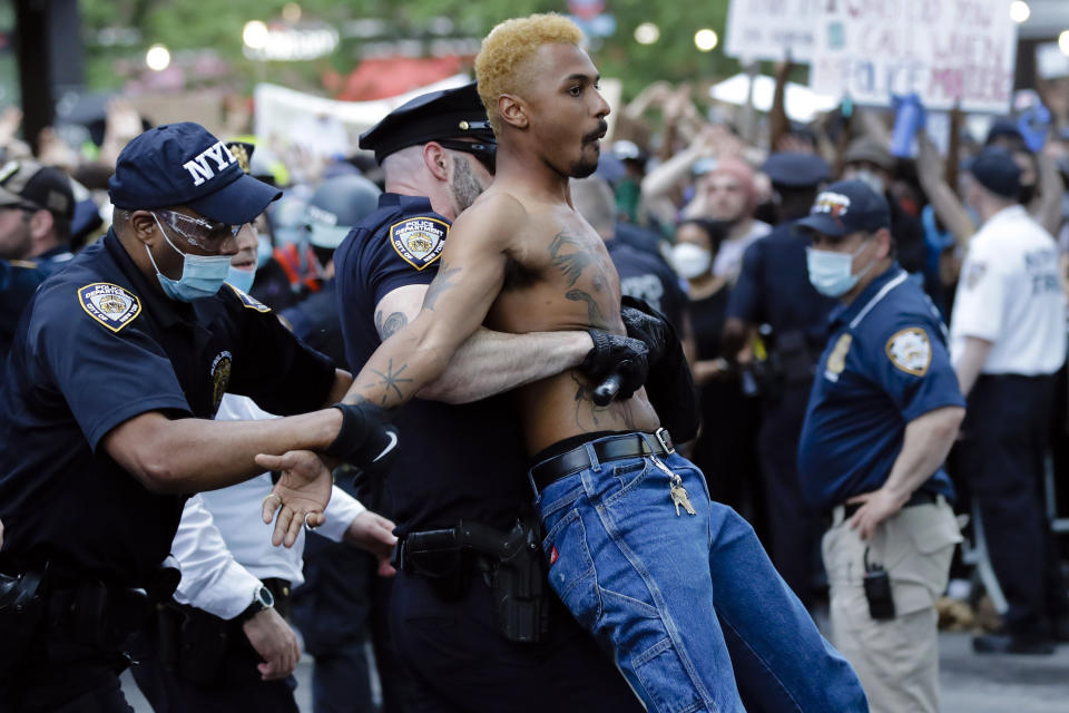 FILE — In this May 29, 2020 file photo, a protester is arrested during a rally at the Barclays Center, in the Brooklyn borough of New York, over the death of George Floyd, in Minneapolis. The New York Police Department was caught off guard by the size and scope of the spring protests sparked by the police killing of George Floyd in Minneapolis and resorted to disorder control tactics that stoked tensions and stifled free speech rights, the city's inspector general said in a report released Friday, Dec. 18, 2020. (AP Photo/Frank Franklin II, File)