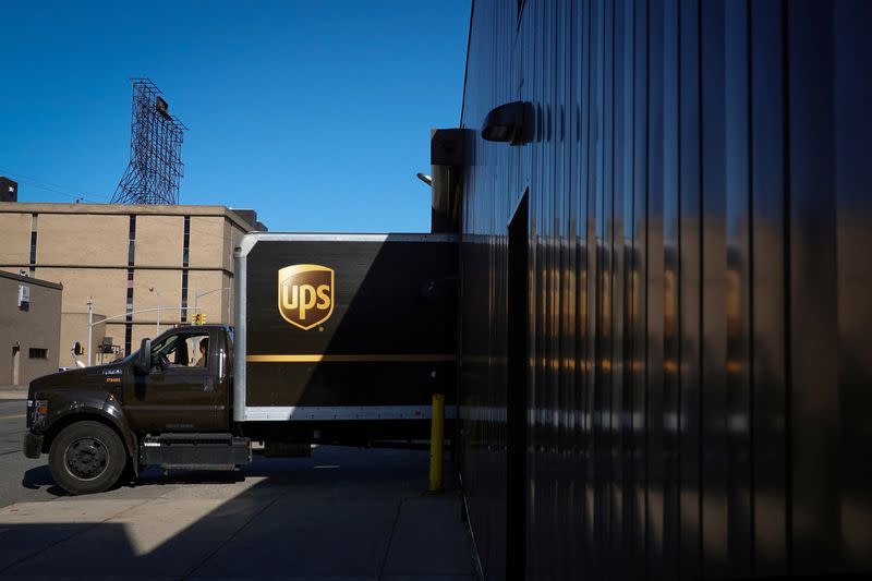 FILE PHOTO: A United Parcel Service (UPS) vehicle reverses into a facility in Queens, New York City