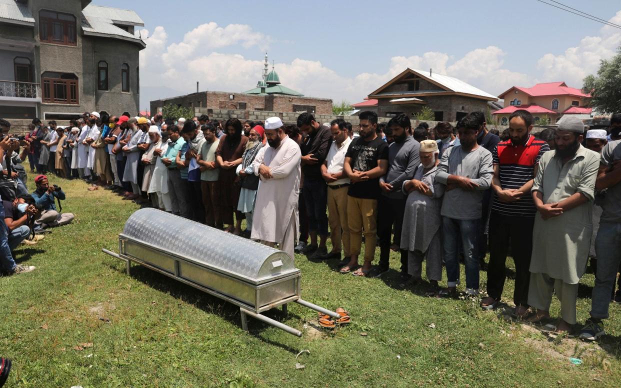 Kashmiri Muslims offer funeral prayers near the coffin of Bashir Ahmad Khan - Shutterstock