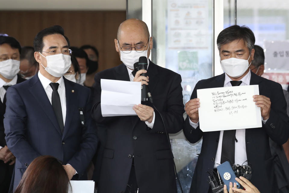 Officials from the Seoul Metropolitan Government show a note, right, of deceased Seoul Mayor Park Won-soon at a hospital in Seoul, South Korea, Friday, July 10, 2020. The mayor left the note saying he felt “sorry to all people” before he was found dead early Friday, officials in the South Korean capital said as people began mourning the liberal legal activist seen as a potential presidential candidate. (Im Hwa-young/Yonhap via AP)