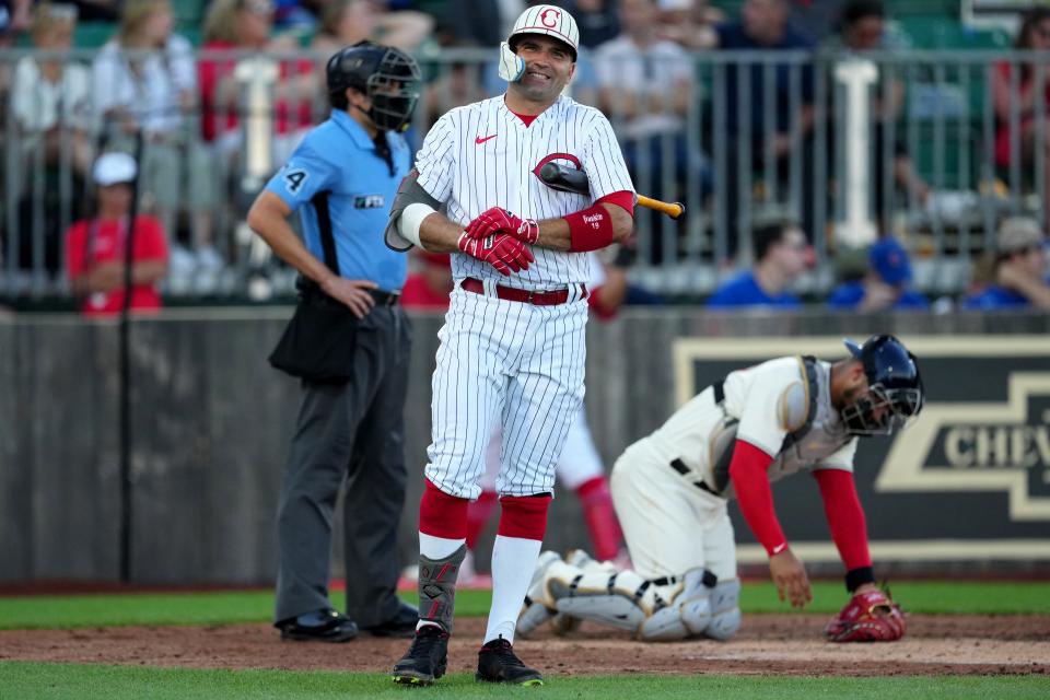 Cincinnati Reds first baseman Joey Votto (19) steps out of the batterÕs box and smiles during his at-bat in the third inning of a baseball game against the Chicago Cubs, Thursday, Aug. 11, 2022, at the MLB Field of Dreams stadium in Dyersville, Iowa. 